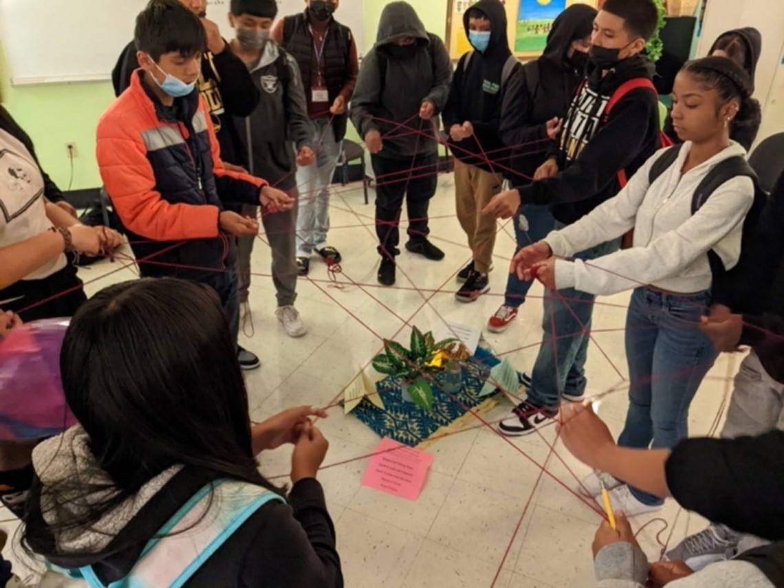 9th graders in the “wheel class” participate in a commitment circle in which they decide on community agreements.