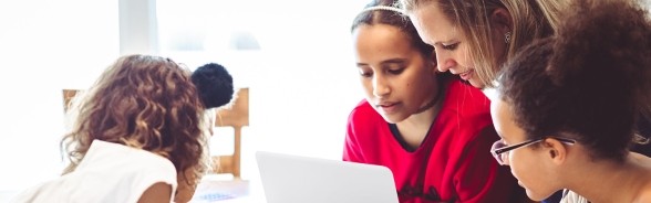 Students looking at laptop