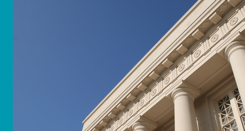 Government building with columns against blue sky