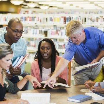 Teachers working together in a library