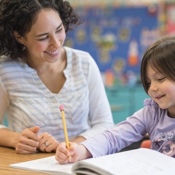 happy student working with teacher