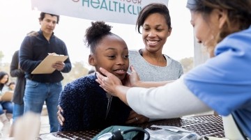 Nurse checklist student at a school health fair