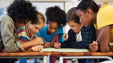 Group on middle school students working on a project.