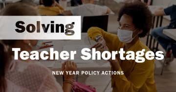 White text over a darkened photo of a teacher wearing a mask helping a student: "Solving Teacher Shortages: New Year Policy Actions" 