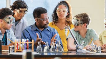 Science teacher in a lab with group of students