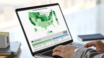Interactive map displayed on laptop screen while someone is typing.