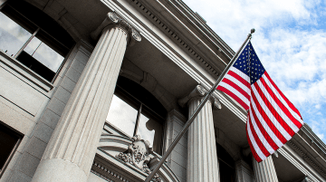 United States of America flag flying in front of a government building
