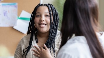 Student talking to teacher one-on-one
