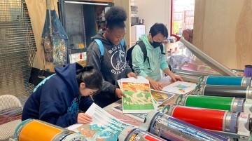 Students working collaboratively on a screen printing project.