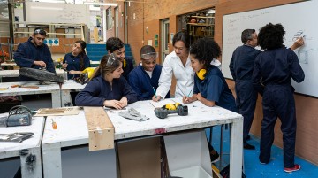 Group of students working with teachers at a workshop.