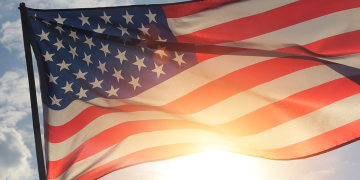 United States flag backlit by sun