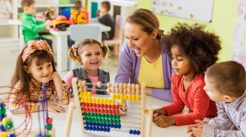 young children working with a teacher