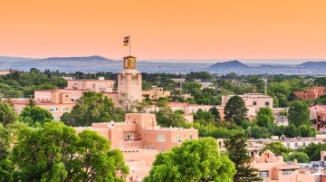 Santa Fe cityscape with the Bataan Memorial Building in foreground and mountains in the background