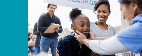 Middle school student being checked by a nurse at a health event