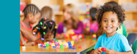 Preschool-aged student playing with developmental toys