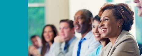 Adults sitting in a row watching a presentation