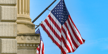 American flag against blue sky on a government building