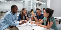 Group of adult students collaborating in a classroom.