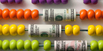 Rainbow colored abacus interspersed with dollar bills