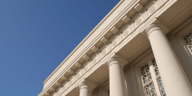 Government building with columns against blue sky