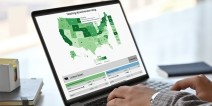 Interactive map displayed on laptop screen while someone is typing.