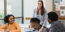 A teacher interacting with high school students.