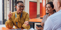 A group of educators seated at a table having a discussion.