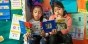 Two elementary girls reading Spanish language books.