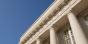 Government building with columns against blue sky