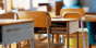 Close up of empty desks in a classroom.