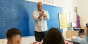 Teacher talking to student in front of classroom