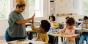 Teacher high-fiving student in classroom