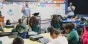 A teacher presenting a lesson while a student teacher watches.