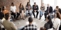 A group of adults having a discussion while seated in a circle.