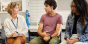A counselor having a serious discussion with two high school students.