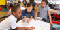 Three students working collaboratively on a school project.