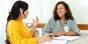 Two educators having a discussion in a classroom.